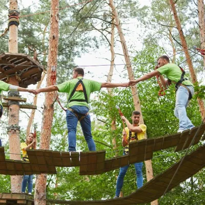 Grupp människor på en höghöjdsbana i skogen